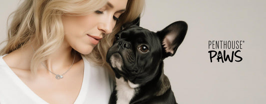 a woman staring down at her small, black dog.